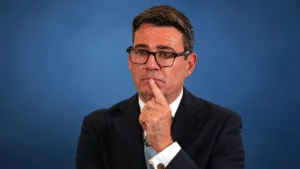 Andy Burnham pictured against a blue background.