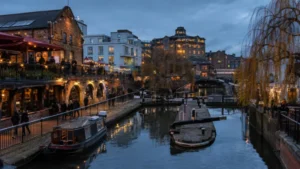 London canal lock system at dusk with boats and reduced water levels