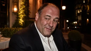 Middle-aged man in a dark suit photographed at a nighttime outdoor event