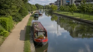 Narrowboats moored along a London canal during ongoing drought restrictions