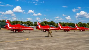 Red Arrows aircraft lined up at a UK airfield with RAF personnel.