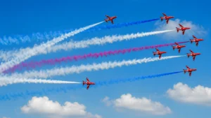 Red Arrows jets performing an aerial formation with red, white and blue smoke trails.