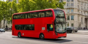 Red double-decker bus travelling through central London