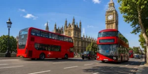 Red double-decker buses near Westminster and Big Ben
