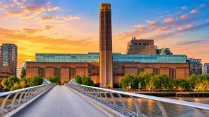 Tate Modern in London viewed from the Millennium Bridge with its iconic former power station architecture.