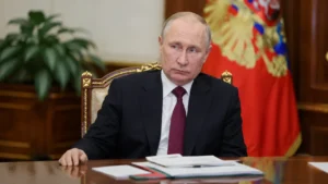Vladimir Putin seated at a desk during an official meeting
